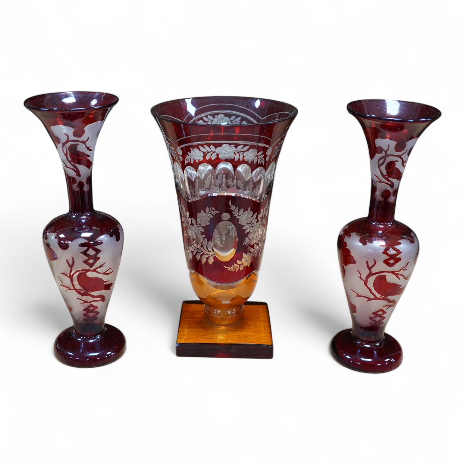 A Czechoslovakian red and amber cut glass square base vase, 21cm high and a pair of similar vases